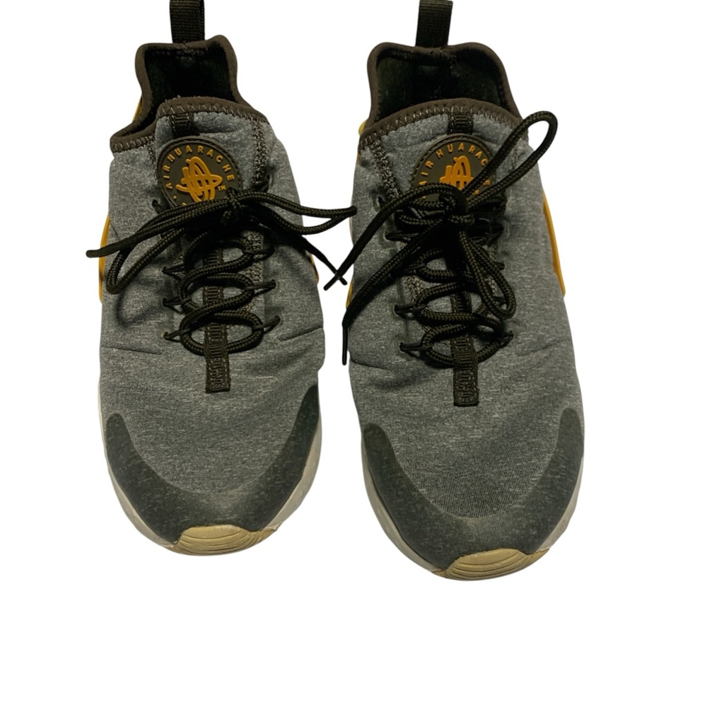 Nike Air Huarache Model Featuring a grey Knit Upper With Yellow Accent